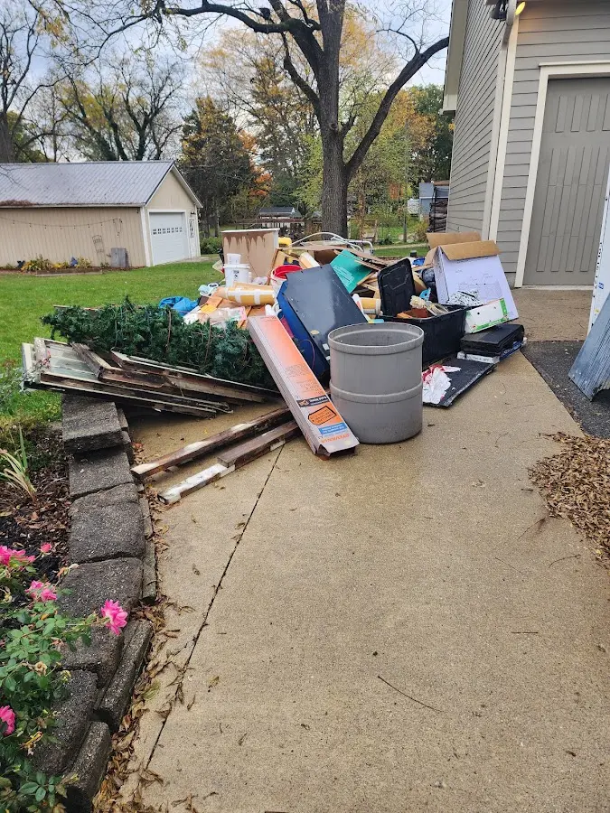 Dumpster being loaded with debris for Commercial Dumpster Rental in Wellesley